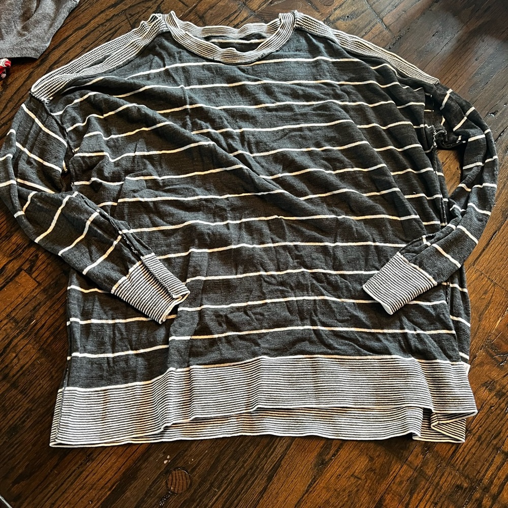 Cold shoulder swing hem sweater